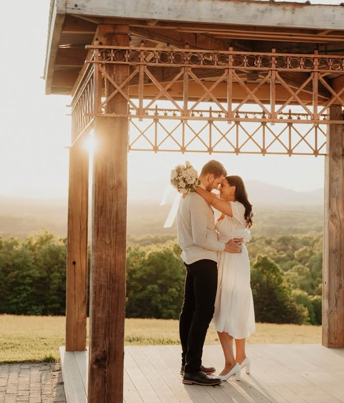 Couple embracing under the pavilion at golden hour