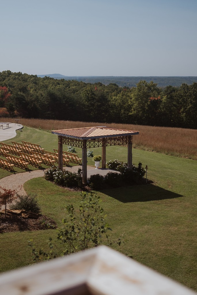 Outdoor wedding ceremony setup with pavilion and mountain views