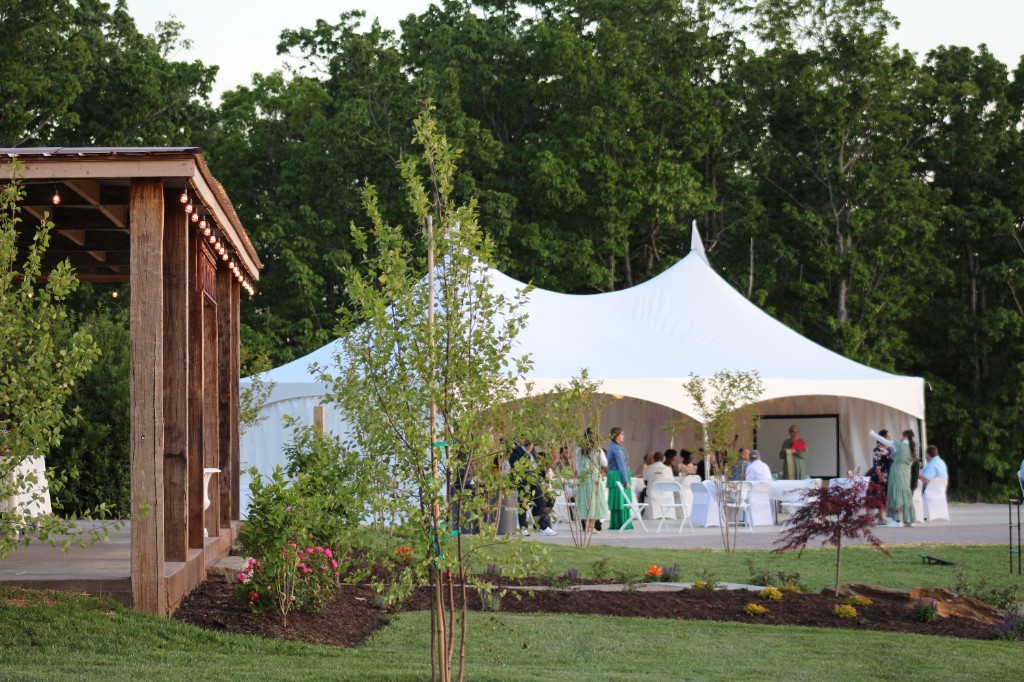 Evening reception under event tent beside the pavilion